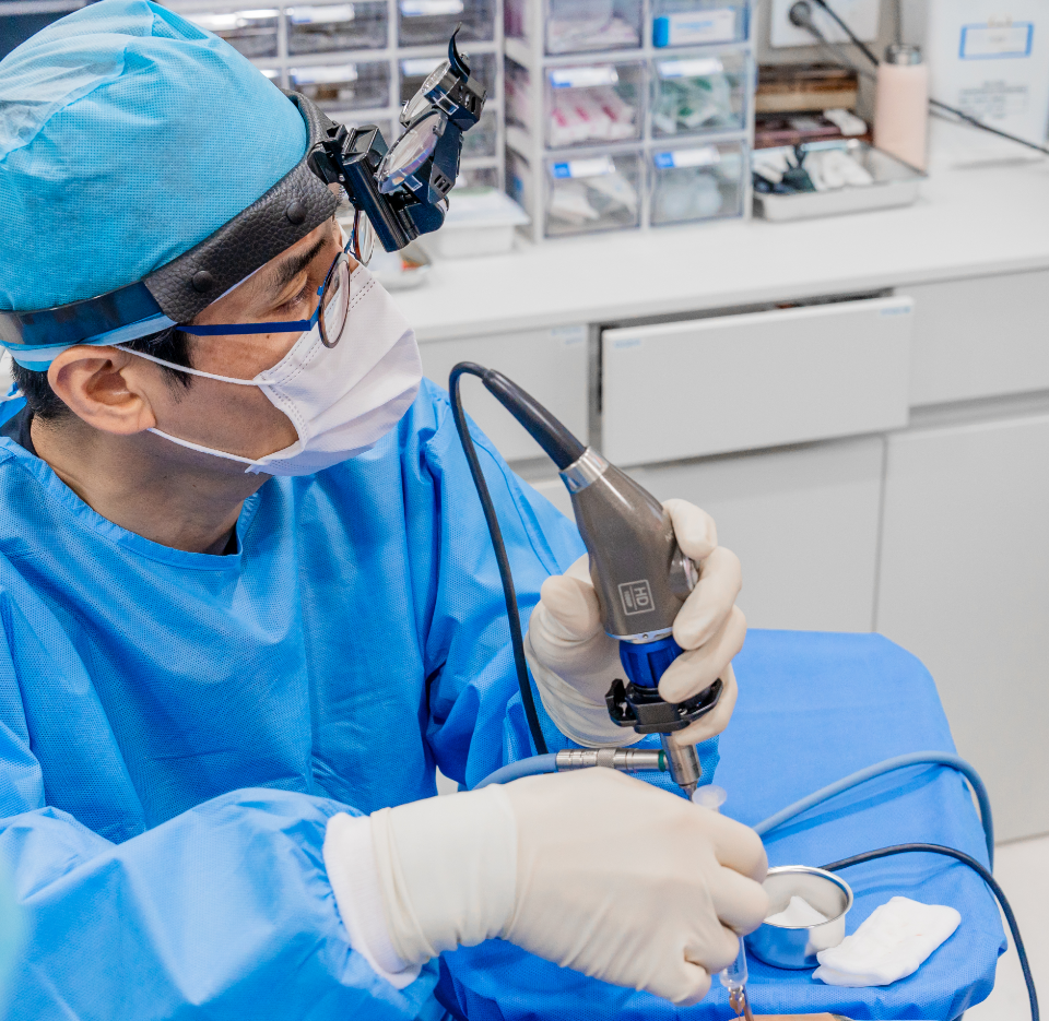 Clinician wearing protective equipment while examining a patient